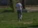 A woman takes a hard shit in an outdoor public park.